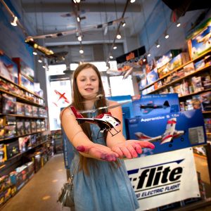 Renee Dickey, the daughter of Bill Dickey, the manager of Pilotage Fun and Hobby in Midtown Manhattan, with a Blade MCX2 helicopter.